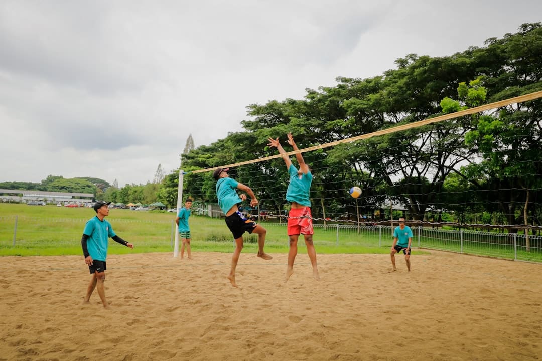 building therapy dog team — a group of young men playing a game of volleyball