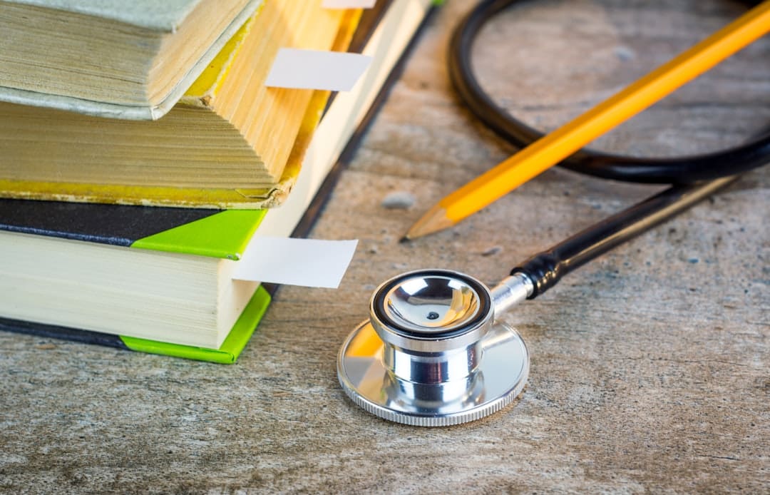 therapy dog program metrics — a stethoscope sitting on top of a pile of books