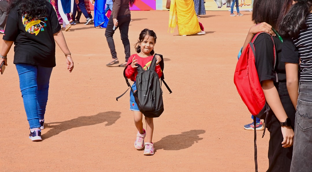 university stress relief — A young girl with a backpack walks outside.