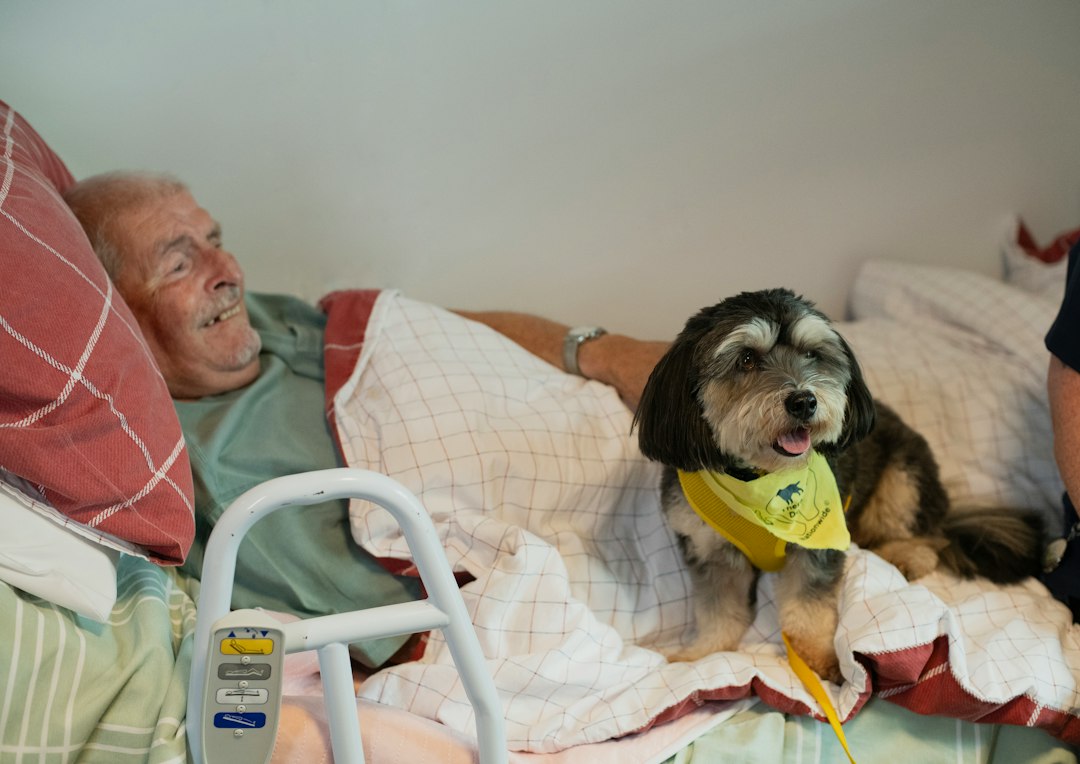 library reading programs — Elderly man and dog in bed